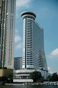 Skyscrapers in Bangkok with clear blue sky, showcasing modern architecture.